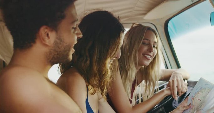Friends on road trip looking at the map