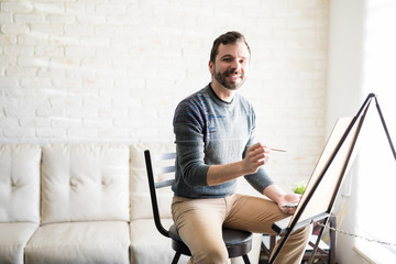 Good looking male painter at home