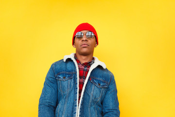 Confident trendy ethnic man on yellow