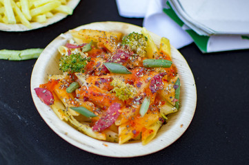 Pasta and fruits in plate of other items