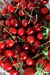 Strawberries and sweet cherries. Berries close-up on a plate