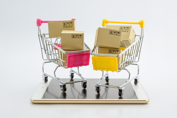 Online shopping with smart mobile device via internet concept : Chromium plated shopping cart on...