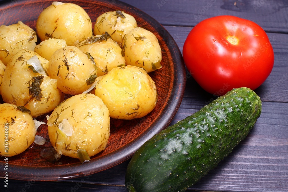 Poster Cooked potatoes on a plate, cucumber, tomatoes