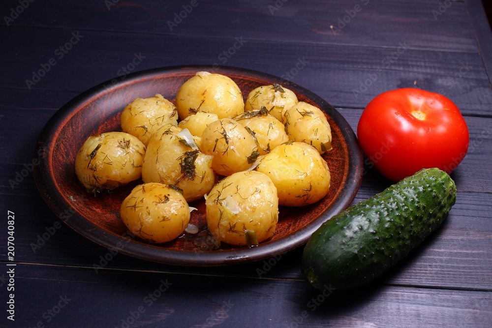 Poster Cooked potatoes on a plate, cucumber, tomatoes