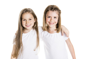 Portrait of two cute friends 7 years old girl Isolated over white background