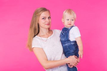 mother and daughter having fun isolated on pink background