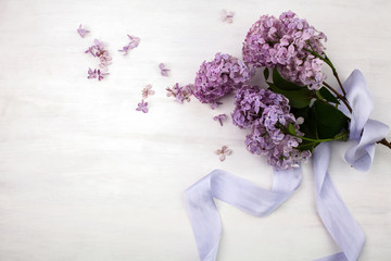 The beautiful lilac on a bright wooden background