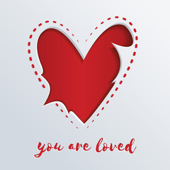 Greeting card with a red heart cut out in paper. You are loved