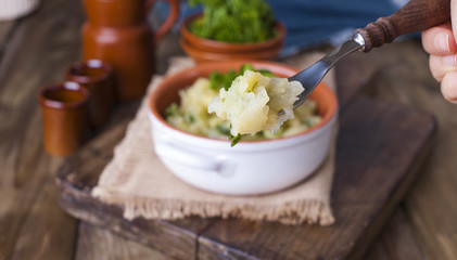 Mashed potatoes in a bowl on a wooden background. Copy space.