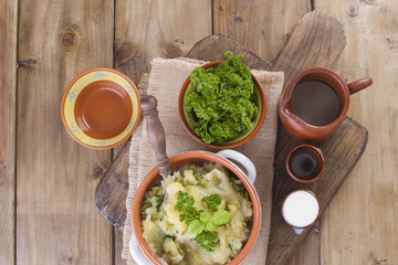 Mashed potatoes in a bowl on a wooden background, flat lay. Copy space.