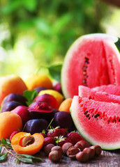 watermelon, hazelnuts, apricots and strawberries on table