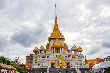 Fototapeta premium People make merit at Buddhist monks' day at Wat Traimit in Bangkok, Thailand.