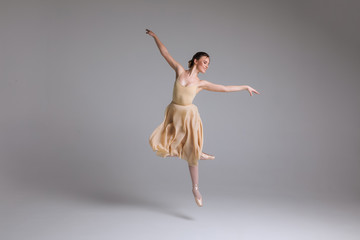 As light as a feather! Young attractive graceful gentle ballerina dancing in the art performance on...