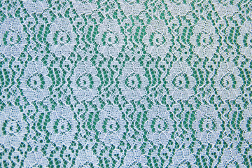 Openwork lace pattern on a green background