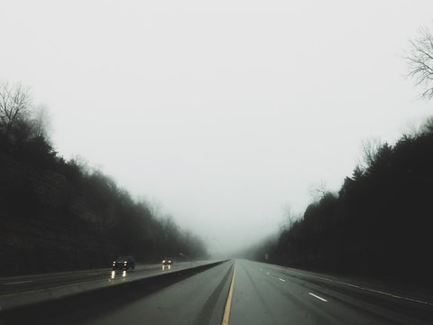 Foggy drive on highway in trees