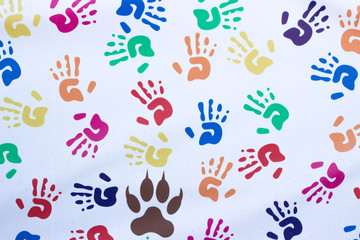 Handprints of children of different colors on a white background