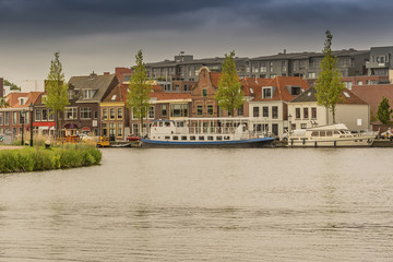 moored boats and houses in alkmaar. netherlands holland