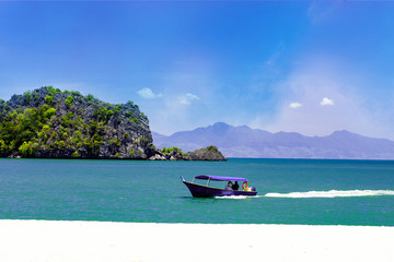 Fototapeta na wymiar Boats for excursion on the beach on the island of Langkawi
