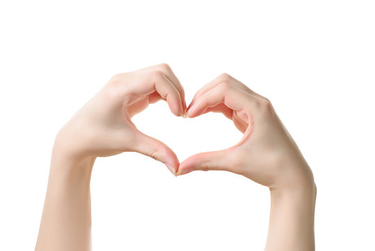Close up of heart made by women hands with pale skin isolated on over white background