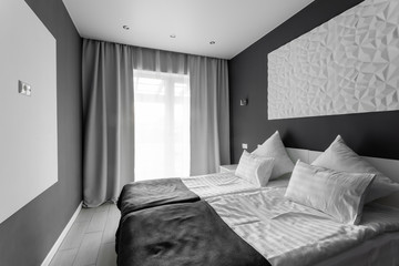 daylight morning. Hotel standart room. modern bedroom with white pillows. simple and stylish interior.