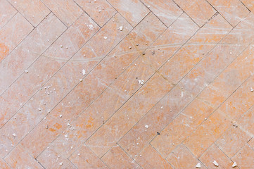 A close-up of an old faded parquet covered with dust and dirt. Result of repair. Cleaning and cleaning required