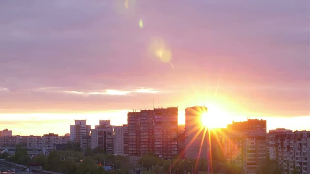 Beautiful sunset on background multi storey building in city time lapse