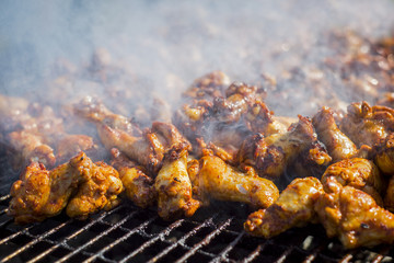 barbecue chicken on the grill with sauce
