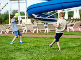 boys play ball football lawn water park