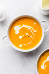 Pumpkin creamy soup decorated with fresh cream
