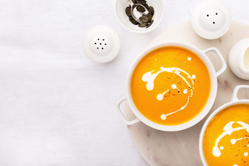 Pumpkin creamy soup decorated with fresh cream