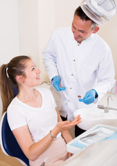 Adult woman is consulting with dentist