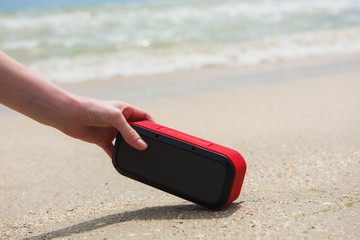 Woman take bluetooth portable speaker