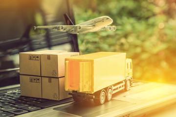 Air courier / freight forwarder or shipping service concept :  Boxes, a truck, white plane flies...