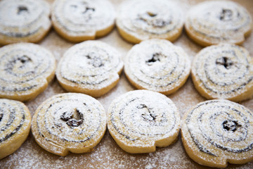 Top view, freshly baked cookies with raisins and poppy seeds on a bamboo board.