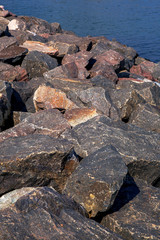 granite stone lie on the seashore.