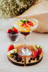 Jelly with fresh berries on table.