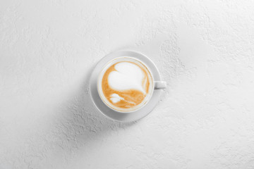 Cup of cappuccino coffee on white background