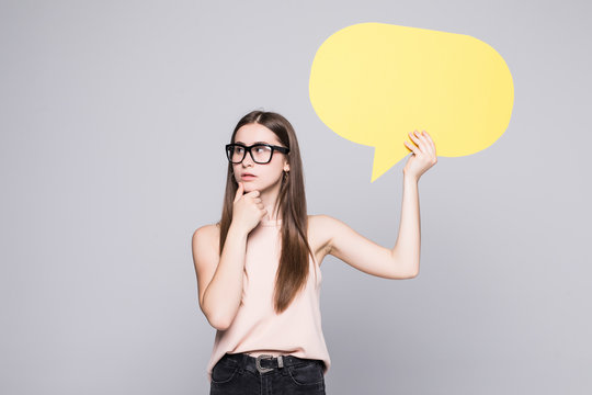 Young beautiful girl holding a speech bubble for text isolated on a white background