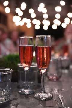 Two glasses of pink Champagne on table