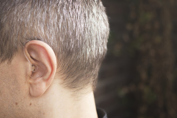 Deaf man hearing aid ear