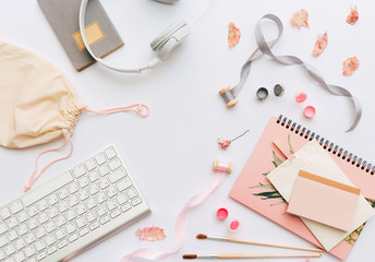 Workspace with decorations, women feminine desktop with keyboard, and headphones