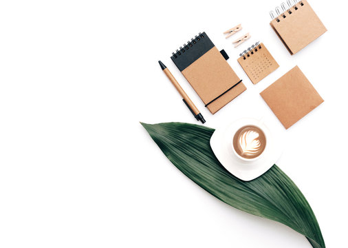 Flat lay home office desk with coffee and stationery 