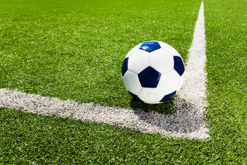 Soccer ball on the white line at field