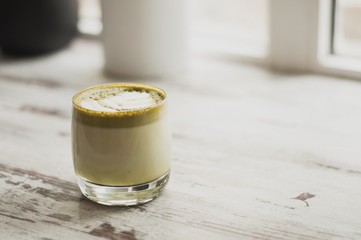 Matcha green tea latte in a cup. Top view. Copy space.