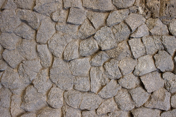 The wall of the house is made of granite formless stone