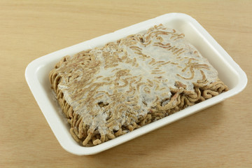 Close up of freezer burned ground beef chuck hamburger meat with frozen ice crystals due to...