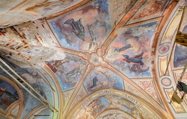 The ceiling with a painting on biblical themes in the abandoned brick Orthodox Church