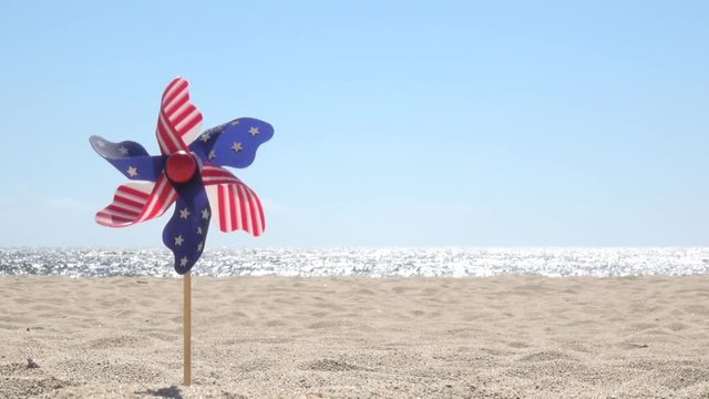 July 4th spinner with stars and stripes on the beach