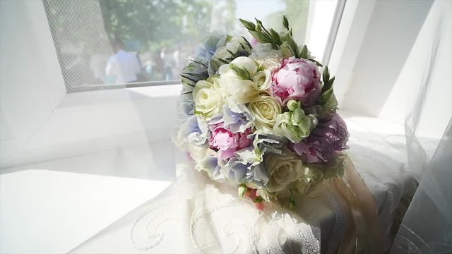 A Bouquet of bride on a wooden window sill