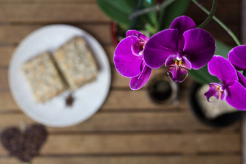 cookies with seeds, coffee, orchid flowers on a wooden background